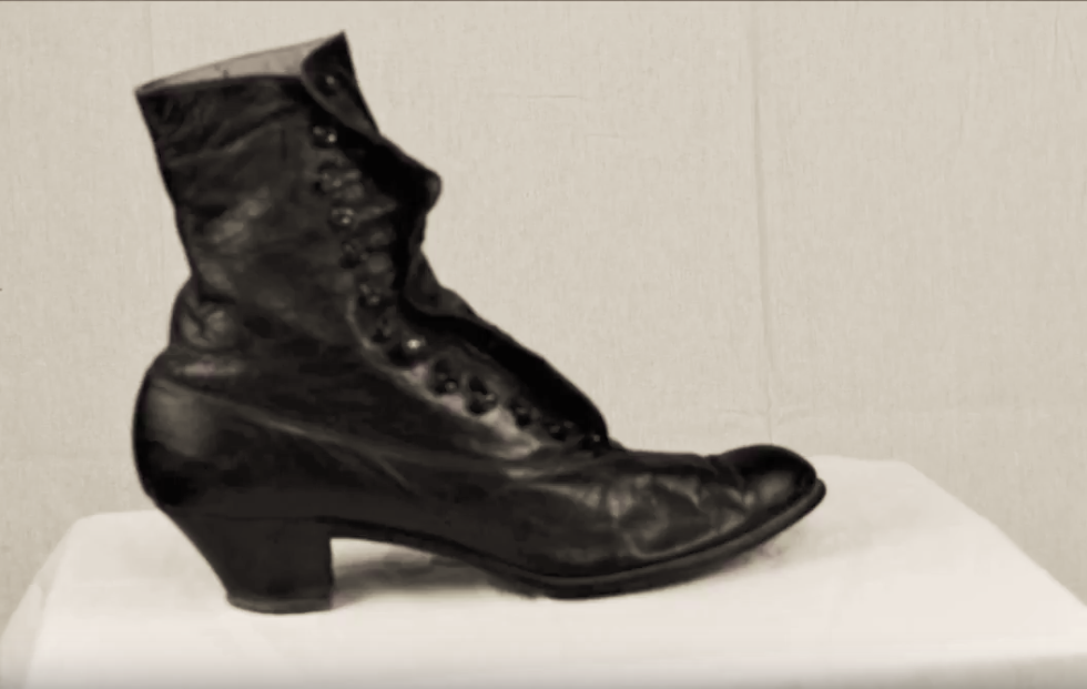 a dark heeled boot on a white background